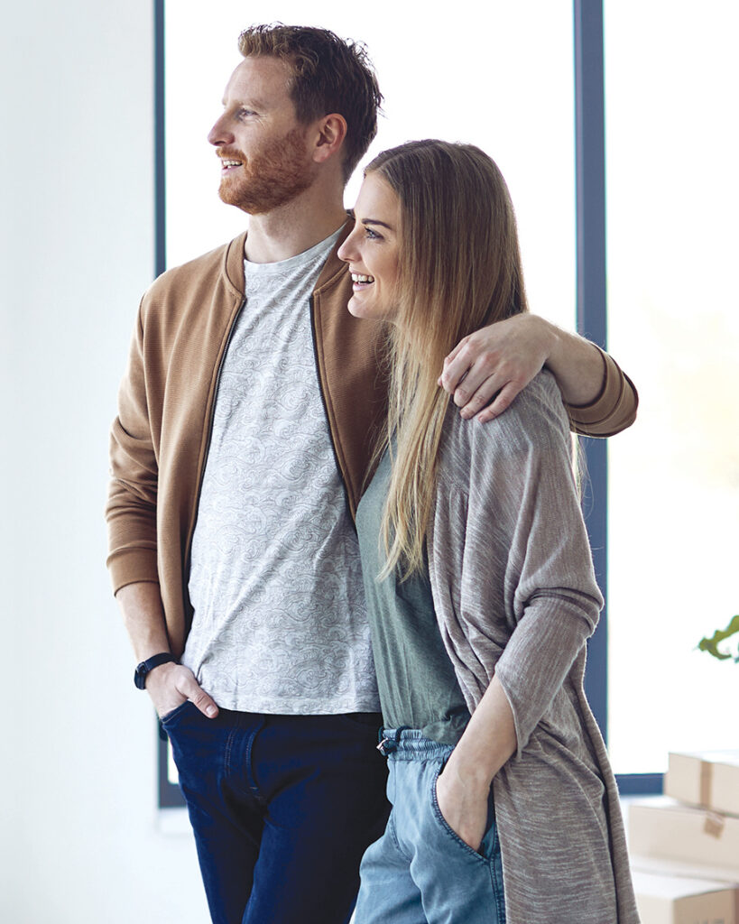 Couple looking out the window in their new home