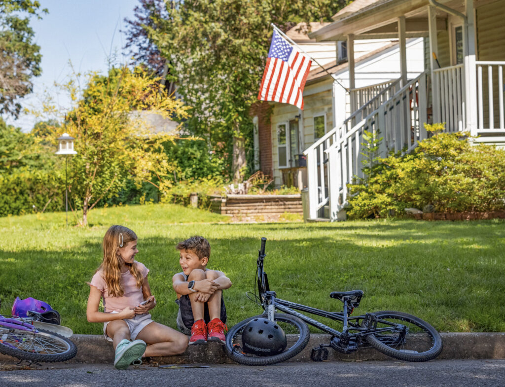 Children play near a home in University City in St. Louis