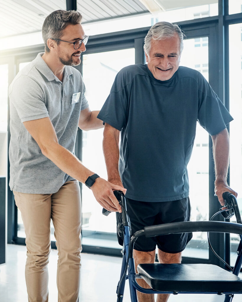 Physical therapist helping a patient walk